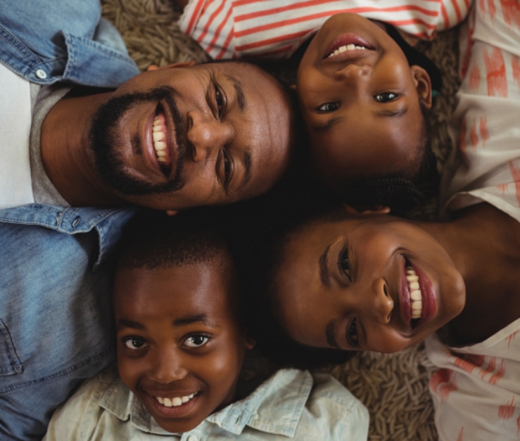 Happy Nigerian family learning Igbo together - parents and children bonding while preserving their cultural heritage through language learning